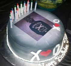 a birthday cake with candles and an xo card on it's frosting