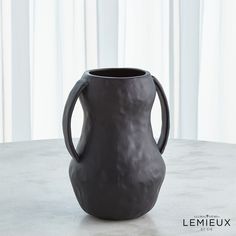 a gray vase sitting on top of a table