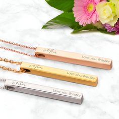 Personalized Pillar Bar Pendant Necklace for Mom in silver, gold and rose gold This elegant Pillar Bar Pendant Necklace is the perfect gift for Mom. If you're looking for a great Mother's day, birthday or just an anytime gift, then this necklace will not disappoint. She'll definitely love this one of a kind gift. The Pillar Bar pendant measures 2" by .25" by .25" with an 18" chain. The "Mom" inscription is done in a beautiful font. Add a personal touch with a laser-engraved message of love that is sure to remind her how much you care every time she wears it. Our necklace comes in 3 different colors, and it is made of stainless steel so it won't fade or rust over time. Get her something she'll love to show off for years to come. All of our products are made with top quality in mind. So, not Rectangular Rose Gold Jewelry For Birthday Gift, Rose Gold Rectangular Jewelry For Birthday Gift, Personalized Rectangular Rose Gold Necklace, Personalized Silver Bar Necklace As A Gift, Personalized Silver Bar Necklace For Gift, Rose Gold Jewelry With Hallmark For Birthday Gift, Personalized Rose Gold Bar Necklace As Gift, Personalized Rose Gold Bar Necklace For Gift, Rose Gold Name Necklace For Birthday And Valentine's Day