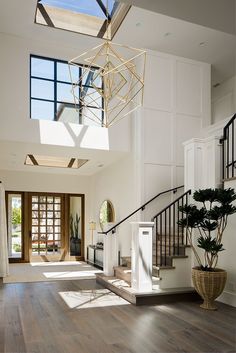 an open floor plan with wood floors and skylights above the stairs, is shown