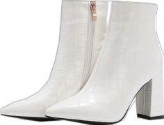 a pair of white high heeled boots with zippers