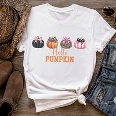 Get into the Fall spirit with this fun shirt featuring cute pumpkins. Perfect for any fall gathering or for running errands. Made from soft, comfortable fabric, it's an ideal choice for anyone looking to show off their love of coffee and fall drinks. Bella and Canvas Brand shirts Unisex Adult Sizing Short sleeved and soft quality Runs True to Size PRINT This shirt is a Direct to Garment printed item where the ink is printed directly into the fabric and does not sit on top like vinyl. SIZING Plea Cute Pre-shrunk Shirt For Fall, Fun Fall T-shirt With Funny Print, Cute Funny Print Shirt For Fall, Cute White Fall Shirt, Fun White T-shirt For Fall, Cute Short Sleeve Fall Shirt, White T-shirt With Funny Print For Fall, Cute White Shirt For Fall, Cute Short Sleeve Shirt For Fall