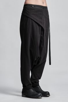 "Drop Crotch Trouser with Asymmetrical Front Closure__ // EXPRESS DELIVERY ONLY __Elastic Backside Waistband with Belt __2 Front Pockets __1 Back Bonded Pockets __Asymmetrical Hidden Front Closure __Soft Cotton Fabric model__ bust 92 (36\"), waist 72 (28\"), hips 102 (40\"), biceps 28 (11''), height 177 (5'8\"), kg 65 (143 lbs) model wears size M | color: black fabric__ 100 cotton care__ delicate machine wash at 30 c wash inside out use cool iron do not tumble dry sizing__ size XS (US 4, EU 34, Fitted Black Bottoms With Irregular Shape, Fitted Irregular Black Bottoms, Workwear Bottoms With Belt Loops And Asymmetrical Hem, Asymmetrical Hem Bottoms With Belt Loops For Work, Asymmetrical Cotton Bottoms For Work, Black Asymmetrical Hem Bottoms For Work, Black Pants With Asymmetrical Hem For Work, Black Asymmetrical Hem Pants For Work, Black Asymmetrical Hem Workwear Pants