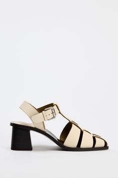 LEATHER CAGE SANDALS - White | ZARA United States Summer T-strap Sandals With Sculpted Heel, Modern T-strap Sandals With Buckle For Spring, Spring T-strap Sandals With Sculpted Heel, Spring T-strap Sandals With Tang Buckle, Summer T-strap Sandals With Padded Heel, Modern Spring Heels With Tang Buckle, Spring T-strap Sandals With Stacked Heel, Spring Sandals With Block Heel And Tang Buckle, Spring Block Heel Sandals With Tang Buckle