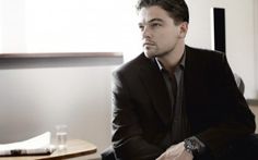 a man in a suit sitting at a table