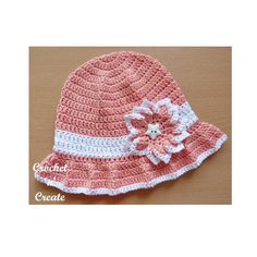 a crocheted hat with a flower on the front and white trim around the brim