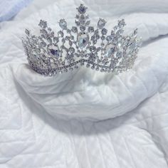 a tiara sitting on top of a white cloth