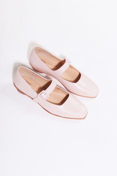 The Eugenia Flat is a modern interpretation of the classic mary jane flat featuring a square toe, angular topline and oval-shaped heel. This pair is crafted from pale pink kidskin leather and a matching buckle.  Who it's for: The woman who is looking for mood-enhancing emotional pieces that defy reason, yet work perfectly with her style and sense of expression.  Kidskin upper and undyed vegetable-tanned leather lining. Leather sole with stacked leather heel measuring 18mm. Handmade in Argentina Classic Square Toe Mary Janes For Spring, Classic Spring Mary Janes With Square Toe, Modern Low Heel Mary Janes For Spring, Modern Mary Janes With Buckle Closure For Spring, Classic Pink Round Toe Ballet Flats, Classic Pink Ballet Flats With Round Toe, Spring Beige Leather Mary Janes, Spring Leather Mary Janes With Square Toe, Beige Leather Mary Janes For Spring