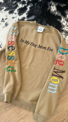 a brown sweatshirt with the words, i'm my dog mom kid on it