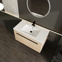 a white sink sitting under a mirror next to a wall mounted faucet in a bathroom