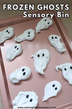 there are many fake ghost cookies on the baking sheet