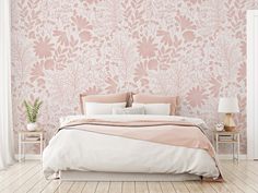 a bedroom with pink wallpaper and white bedding