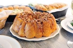 a bundt cake sitting on top of a white plate next to other food items