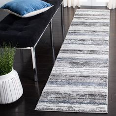 a black and white striped rug in a living room