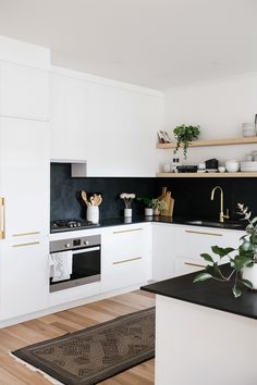 the kitchen is clean and ready for us to use it's white cabinetry