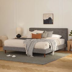 a large bed sitting on top of a wooden floor