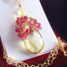 "NOTE: This necklace is Custom Made to Order and will vary slightly from the original. The \"Millefeuille Rose\" features a LARGE faceted and flawless lemon quartz briolette accented with lush, dense clusters of faceted hot pink corundum rondelles, faceted hot pink sapphire rondelles, faceted pink sapphire briolettes, faceted raspberry-pink tourmaline rondelles, faceted hot pink tourmaline rondelles, faceted citrine rondelles, facet3ed citrine briolettes, a petite faceted lemon quartz faceted ov Elegant Yellow Faceted Gemstones, Elegant Citrine Briolette Necklace, Elegant Citrine Gemstone Beads Necklace, Elegant Citrine Gemstone Bead Necklaces, Handmade Elegant Citrine Gemstones, Elegant Handmade Citrine Gemstones, Elegant Citrine Gemstones For Jewelry Making, Lemon Quartz Necklace, Lemon Quartz