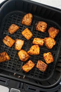 cubed tofu being cooked in an air fryer