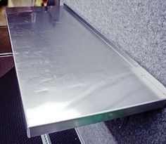 a metal table sitting on top of a carpeted floor