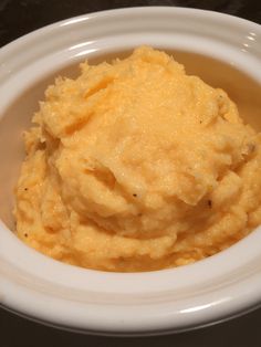 mashed potatoes in a white bowl on a table