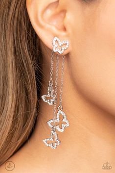 Cascading from a solitaire, rhinestone-encrusted butterfly, a trio of butterfly silhouettes in varying sizes with a similar sparkle attaches to a double-sided post as it cascades from dainty silver chains for an eye-catching flutter below the ear. Earring attaches to a standard post fitting.Sold as one pair of double-sided post earrings. Butterfly White, Coil Bracelet, Silver Chains, The Ear, Paparazzi Accessories, Paparazzi Jewelry, White Earrings, Butterfly Earrings, White Jacket