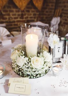 a table with flowers and candles on it