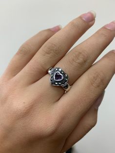 Beautiful sterling silver ring featuring a heart-shaped amethyst and sparkling marcasite accents, stamped 925. Made with ethical gemstones, this ring combines elegance with a touch of romance. Perfect for adding a unique and sophisticated charm to any outfit. Don't miss out on this exquisite piece! Ring Size: 5 3/4 U.S.  Weight: 4.0 grams  *missing a single marcasite stone Silver Sterling Silver Amethyst Ring For Valentine's Day, Valentine's Day Silver Amethyst Ring In Sterling Silver, Silver Heart-shaped Amethyst Ring, Silver Heart-shaped Birthstone Ring With Gemstone, Heart-shaped Silver Amethyst Ring, Marcasite Gemstone Ring For Anniversary, Silver Heart-shaped Amethyst Ring For Anniversary, Silver Amethyst Heart Ring For Anniversary, Amethyst Heart