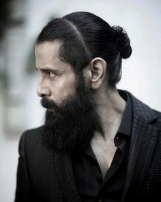 a man with a long beard and black shirt