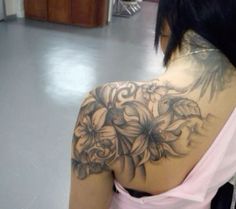 the back of a woman's shoulder with flowers on it