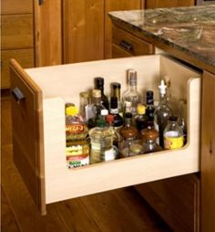 the kitchen drawer is full of bottles and spices