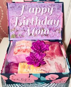 an open birthday box with flowers and soaps in it