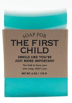 the first child soap bar is shown in blue and brown paper with an inscription on it