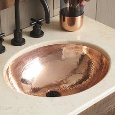 a bathroom sink that has some flowers in it