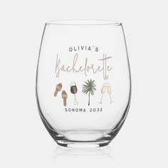 a wine glass with the names of two people and a palm tree