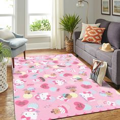 a living room with a couch, chair and hello kitty rug on the floor in front of a window