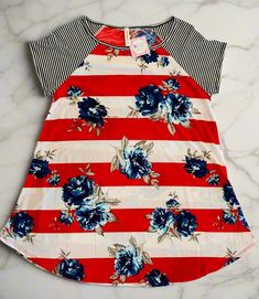 This red, white, and blue floral top is perfect for celebrating Memorial Day, 4th of July, Labor Day and any other day! Stand out this Summer in our cute plus size tunic – it's longer length and soft, stretchy fabric makes it ideal for curvy women to feel confident and comfortable! Don't miss your chance to show your American pride in style. Make this your favorite holiday and be ready for the fireworks, and compliments, to fly! Boom! Striped Shirt Details: 1xl: 44" Chest 30" Length 2xl: 46" Che Mom And Me Shirts, Long Sleeves Shirts, Usa Shirts, Womens Best, Black Biker Shorts, Mom And Me, Blue Floral Top, Matching Mom, Striped Tunic