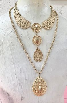 Lot of 2 super cool vintage mid-century gold tone necklaces, sold together only. First one is a fun collar necklace with an ornate circular geometric design. Original necklace was super short, so an extender has been added for adjustability. Hook closure, you can hook to where you like it. Approximately 18.25 inches maximum length. Second necklace has a vintage teardrop shaped medallion. Original clasp was degraded and replaced with a large lobster claw. Adjustable also. 24 inches length, pendan Gold Necklaces With Intricate Metal Design, Vintage Choker Necklace With Intricate Design, Vintage Gold Medallion Necklace, Vintage Gold Necklace With Intricate Design, Vintage Gold Metal Chain Necklace, Antique Gold Metal Necklace With Filigree, Vintage Gold Choker With Intricate Design, Retro Gold Medallion Jewelry, Gold Filigree Metal Necklace