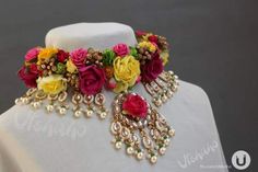 the necklace is adorned with flowers and pearls