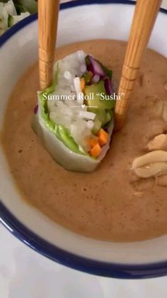 two wooden chopsticks sticking out of a bowl of soup