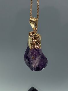 Amethyst was believed to be able to rid the body of all pollutants in ancient times. The stone, according to ancient Greek belief, shields the user from intoxication and helps them maintain mental balance. Amethyst can lower stress levels and encourage better blood circulation. Raw Amethyst Pendant Gold Plated with a chain of your choice, you will get the exact piece you are lookin  at the pictures  1.75 inch length, .75 width. its unique raw form make this pendant one of the kind ready for you or someone you love. Crystal Necklace Healing, Raw Amethyst Crystal, Mental Balance, Amethyst Crystal Necklace, Necklace Amethyst, Raw Crystal Necklace, Raw Amethyst, Amethyst Jewelry, February Birthstone