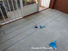 two blue mop's laying on the ground in front of a patio door