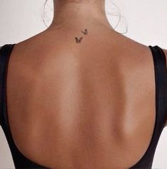 a woman with a butterfly tattoo on her back