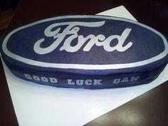 a cake that is shaped like a ford oval with the words good luck day on it