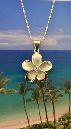 "Solid .925 with 14K Yellow Gold overlay Sterling Silver Hawaiian Plumeria Pua Melia Necklace. The size is 22.5MM (about 0.87\"). FREE Italian 2-tone Sterling Silver chain included in your choice of length. It has a Sandblasted Matte center with High-Polished shiny edges. It features a cubic zirconia in the flowers center for a hint of sparkle. The highly-reflective finish is both stunning and durable. It is designed to mimic the look of fine jewelry at a fraction of the cost. --The Plumeria Flo Flower Necklace Gold, Hawaiian Necklace, Hawaiian Plumeria, Hawaiian Jewelry, Gold Overlay, Flower Center, Love Symbols, Flower Jewellery, Flower Necklace