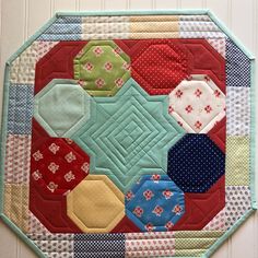 a close up of a patchwork quilt on a wall hanging or table topper