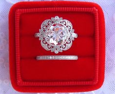 an engagement ring in a red velvet box