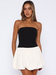 Features: Explore your feminine side with the Joan Ruffled Contrast Slin Mini Dress. This fashion-forward dress features a high waist and patchwork design, perfect for showing off your curves. The strapless and backless design adds a touch of sexiness to your summer wardrobe. Stand out and make a statement with this new must-have dress. Chic White Tube Top For Date Night, Chic White Bandeau Strapless Dress, Chic Backless Tube Top For Summer, Chic White Stretch Strapless Dress, Chic White Backless Tube Top, Fitted Black Strapless Dress For Day Out, Black Fitted Strapless Dress For Day Out, Chic White Mini Tube Top, Chic Strapless Bandeau Dress For Brunch