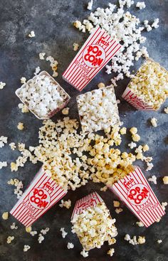 popcorn spilled out of red and white buckets