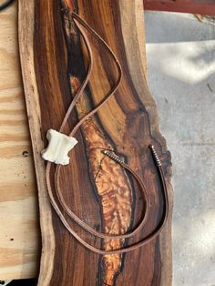 a piece of wood with a cord attached to it