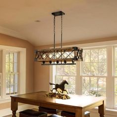 a dining room table with chairs and a horse figurine on top of it